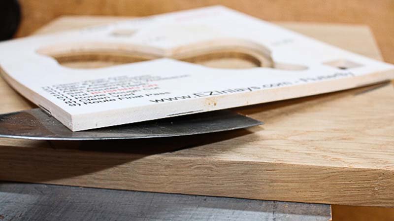 Using a paint scraper to remove the template